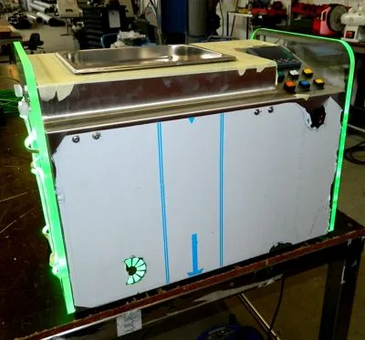 Machine met groen verlichte plexi zijpanelen
